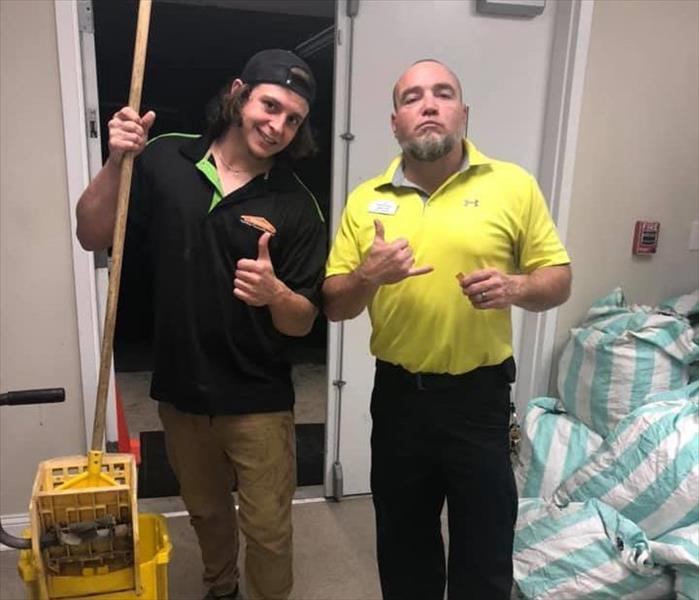 Image shows SERVPRO crew chief standing next to a client.