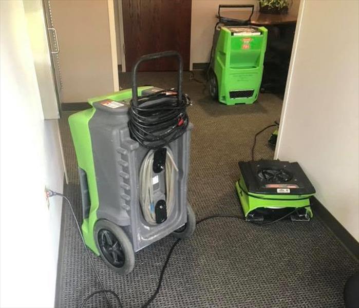 Image shows green SERVPRO drying equipment on carpet.