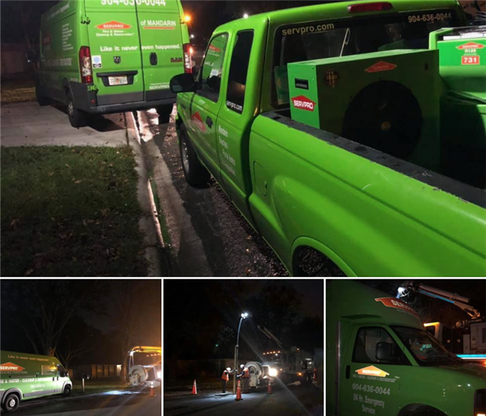 Image shows green SERVPRO vehicles lined up in the street at night.