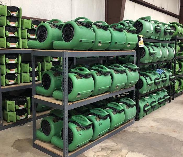 Image shows green SERVPRO air movers on shelves in SERVPRO's warehouse.